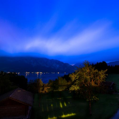 Long exposure photo of blue clouds at night over the Attersee, Austria