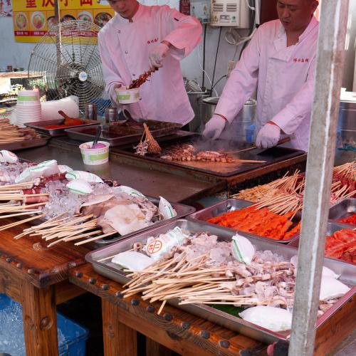 Street food being prepared in a market along the streets of Shanghai